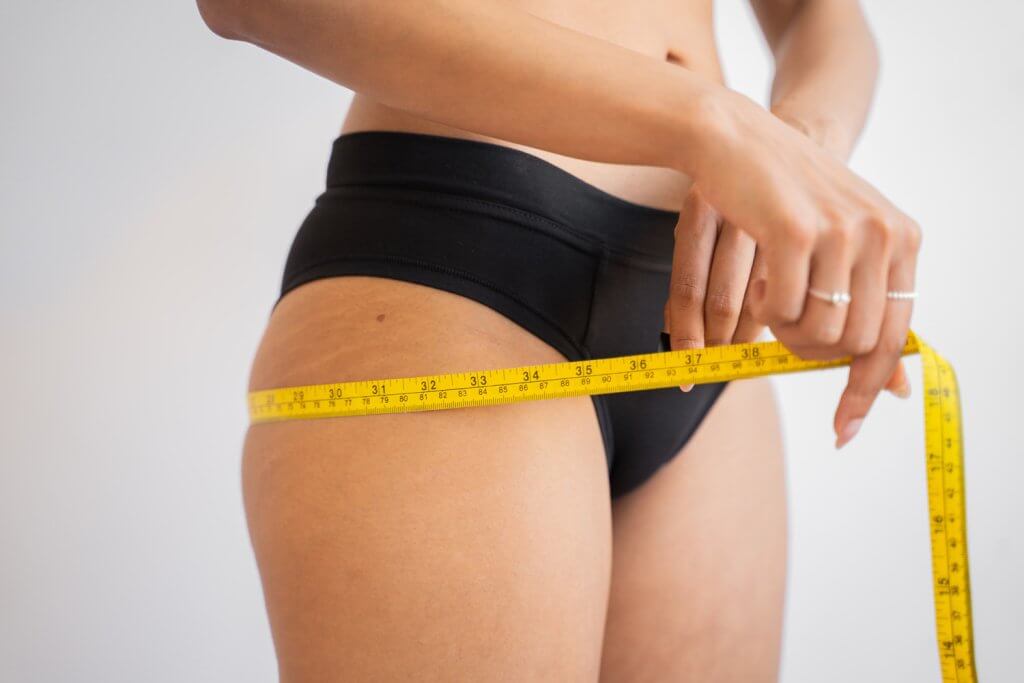 Woman Measuring Body | How to Get Over Weight Loss Resistance